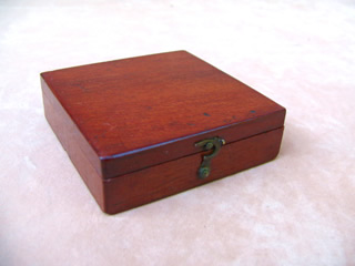 Mahogany cased pocket compass in closed position (top view)