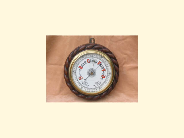 Mahogany cased rope twist aneroid barometer by G R Eve & Co