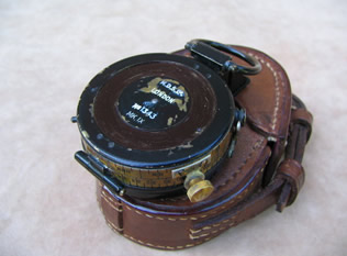 Underside view of compass resting on leather case
